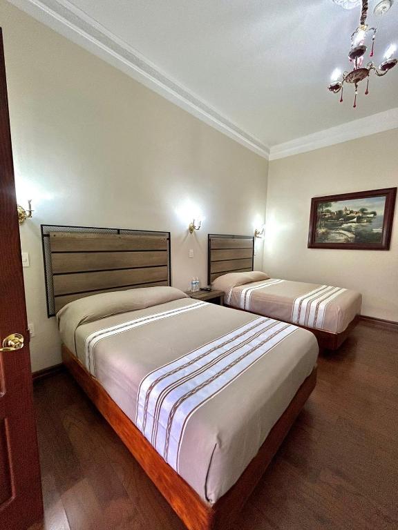 Postel nebo postele na pokoji v ubytování Hotel Cantera Real, Morelia