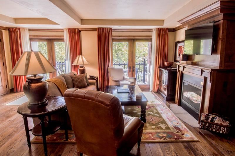 a living room with a couch and a table at Luxury 2 Bedroom Aspen Mountain Residence 23 in Downtown one block to Ski Lifts in Aspen