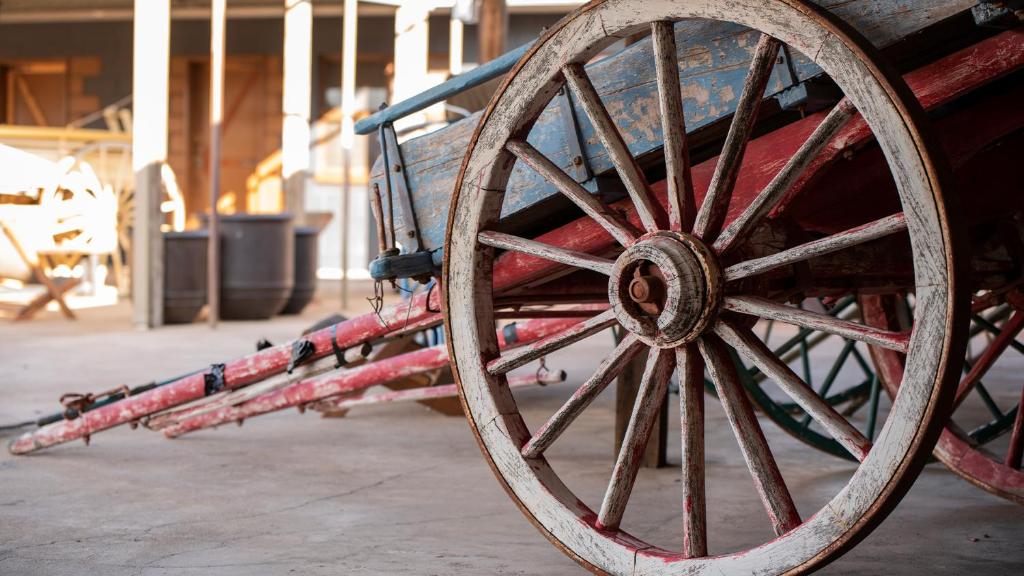 a close up of a wooden wagon wheel at The Staging Post in Longreach