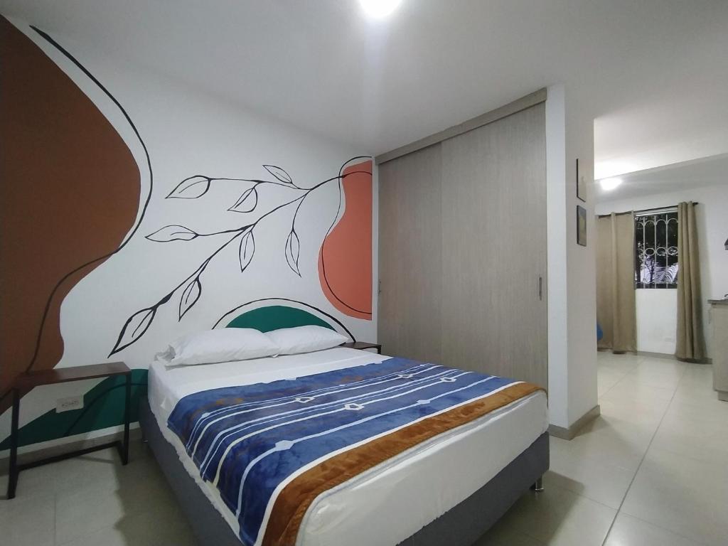 Apartalofts Cali - Parque del Perro 30 m2 tesisinde bir odada yatak veya yataklar