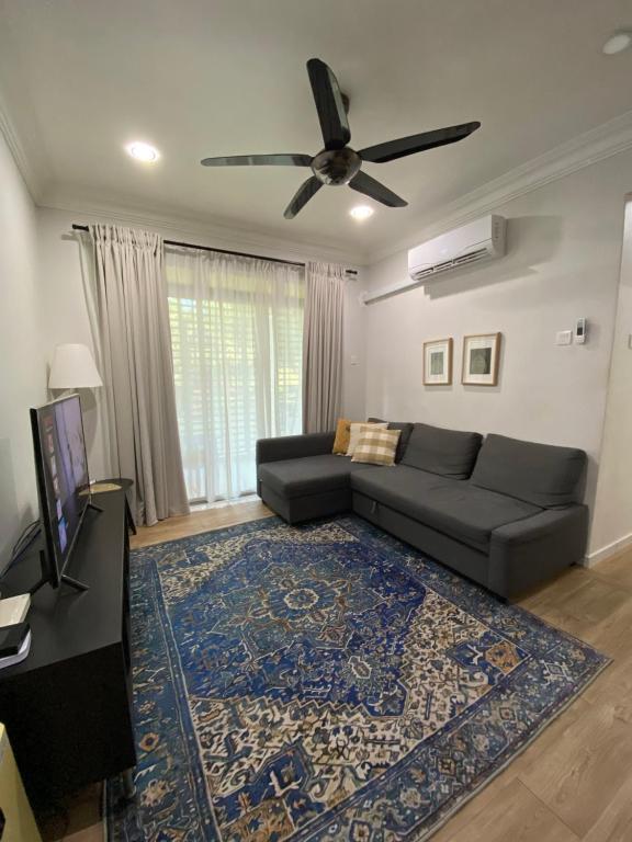 a living room with a couch and a ceiling fan at Homestay Hana Senawang in Seremban