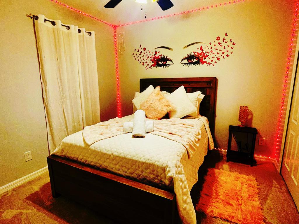 a bedroom with a bed with red lights on the wall at La Suerña in Davenport