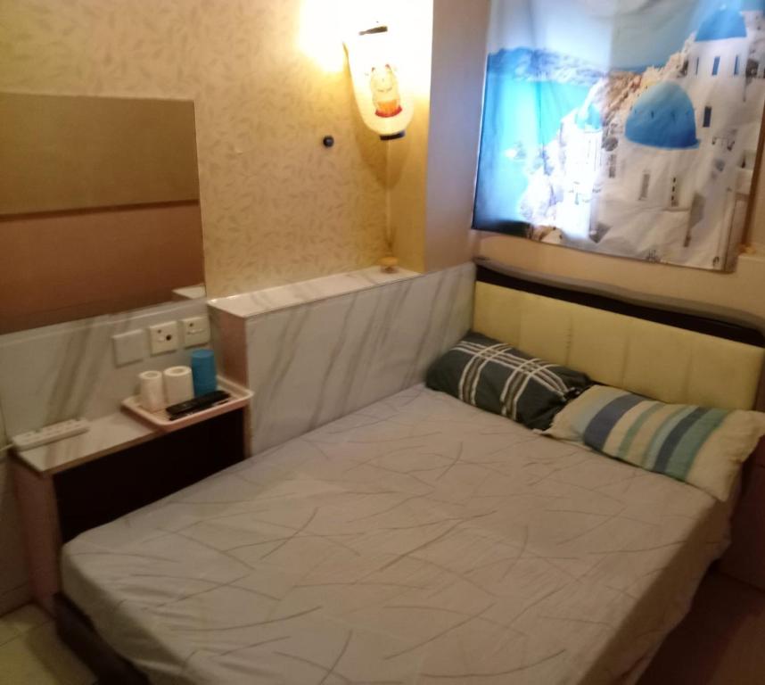 Postel nebo postele na pokoji v ubytování 嘉湖旅館