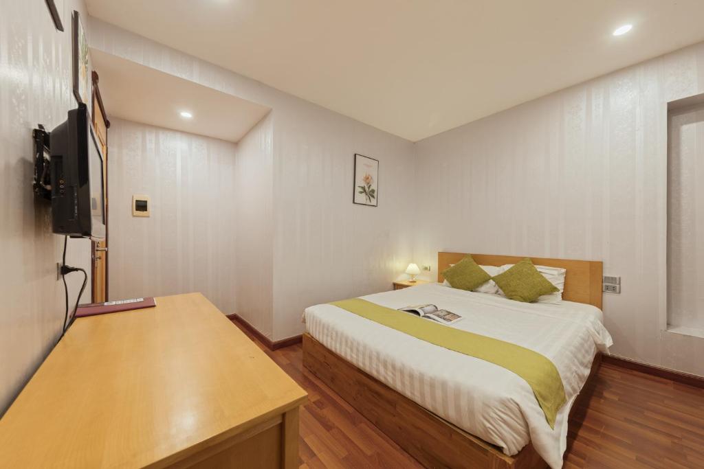 Postel nebo postele na pokoji v ubytování Hanoi Central Park Hotel