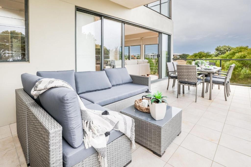 a living room with a couch and a table at Loka 7 beachfront apartment in Agnes Water