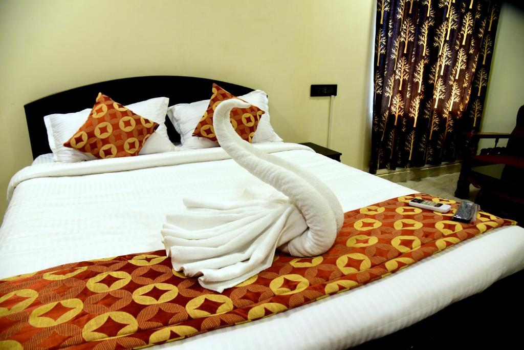 a bed with a swan made out of towels at Home Stay Tirupati in Tirupati
