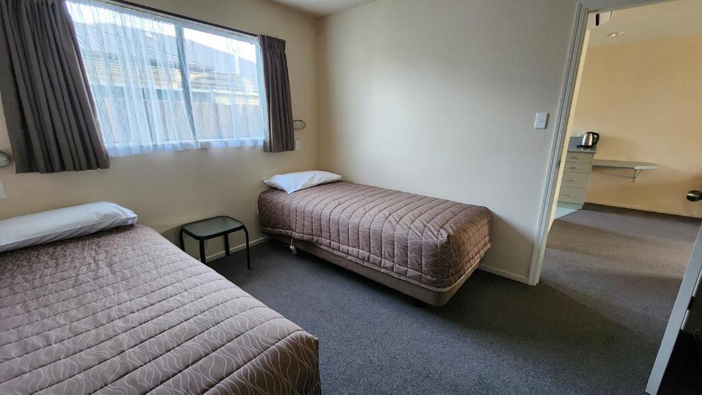 Postel nebo postele na pokoji v ubytování Ashburton's Regency Motel