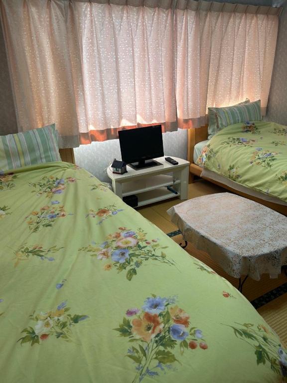 Postel nebo postele na pokoji v ubytování 福寿苑　Fukujuen