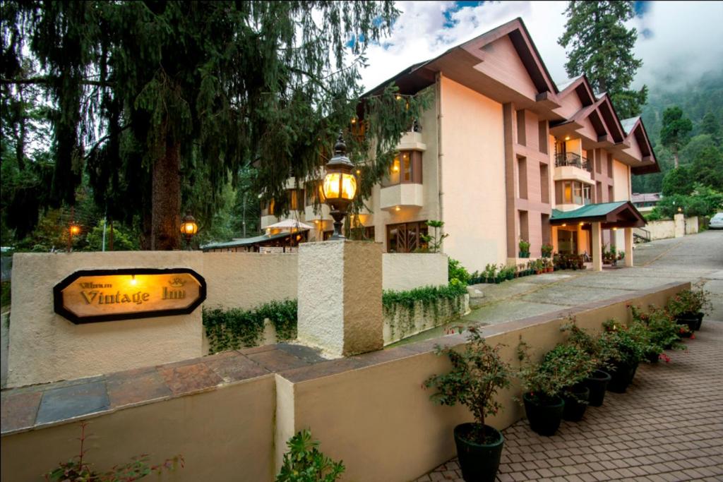 a building with a sign on the side of a street at Vikram Vintage Inn in Nainital