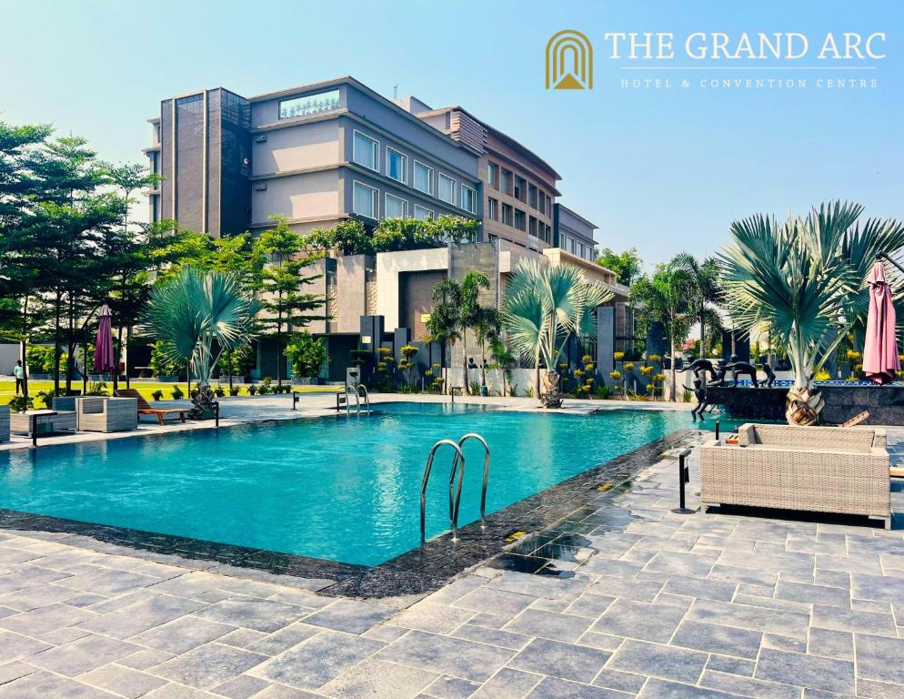 a swimming pool in front of a building at The Grand Arc Hotel & Convention Centre in Shāhjahānpur