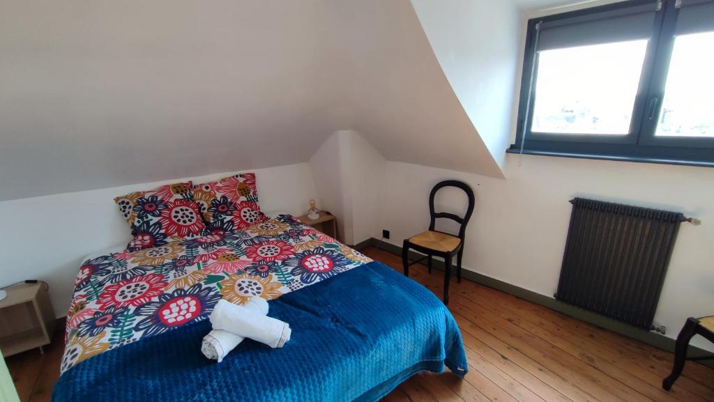 a bedroom with a bed with a teddy bear on it at le panoramique in Quimper