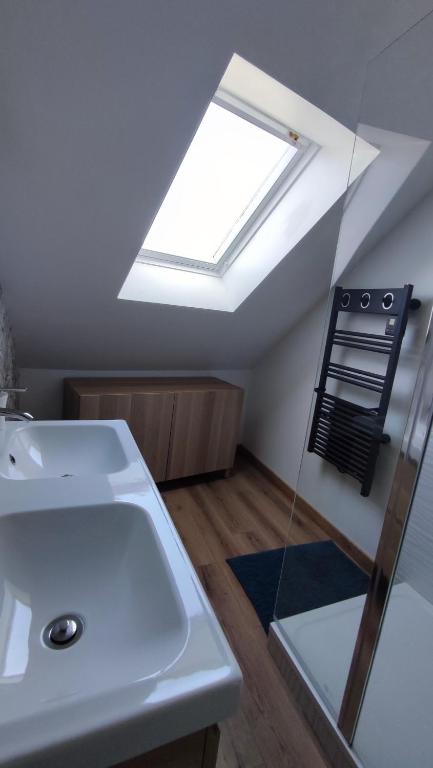 a bathroom with a sink and a skylight at le panoramique in Quimper