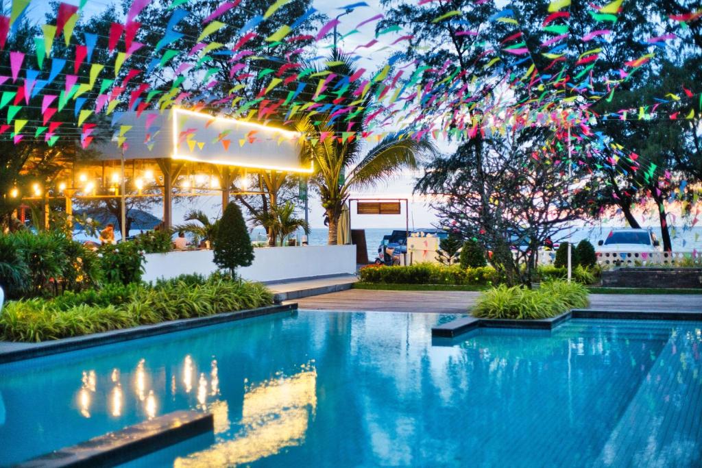 a pool at a resort with colorful streamers at Naiya Sea Resort in Sihanoukville