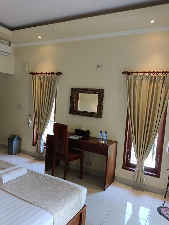 Postel nebo postele na pokoji v ubytování Ketut Kasta Guest House