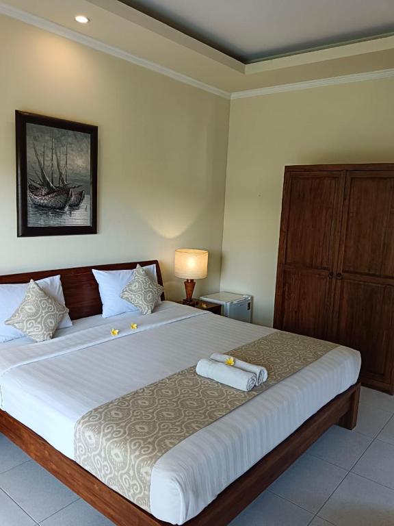 Postel nebo postele na pokoji v ubytování Ketut Kasta Guest House