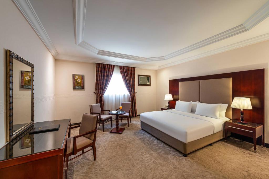 a hotel room with a bed and a desk at Boudl Heraa in Jeddah