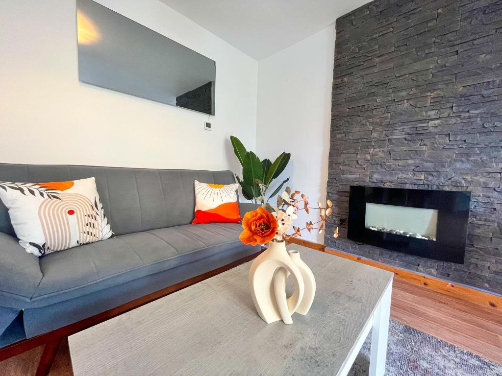 a living room with a couch and a fireplace at Seascape Bliss - Coastal Retreat in Youghal`s heart - Family Friendly - Long Term Price Cuts in Youghal