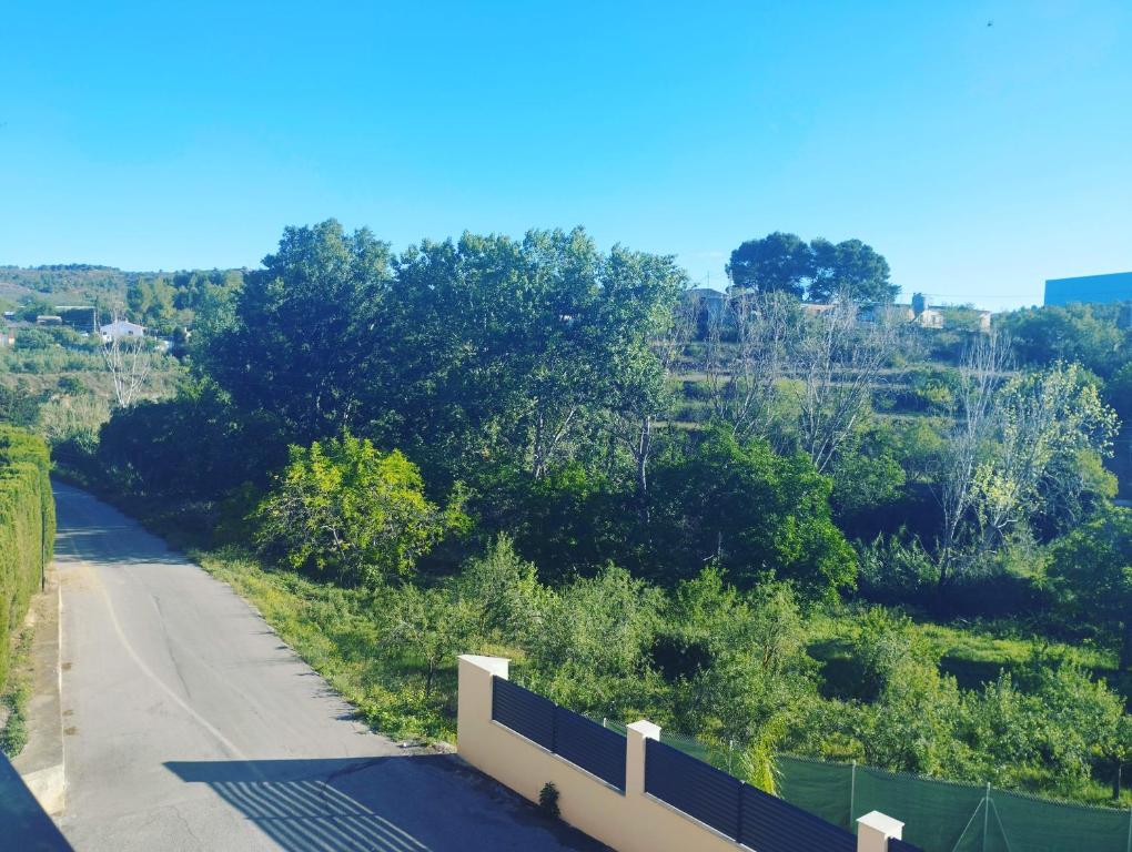 a road with a fence on the side of it at RuralRusticHome in Altura