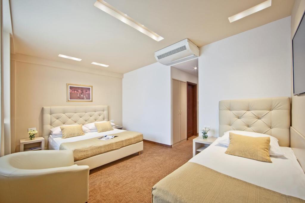 Postel nebo postele na pokoji v ubytování Hotel Central
