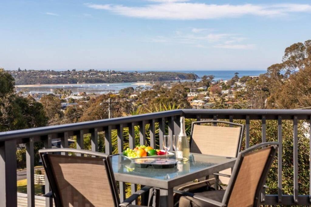 a table with a bowl of fruit on a balcony at Sapphire Sunrise in Merimbula