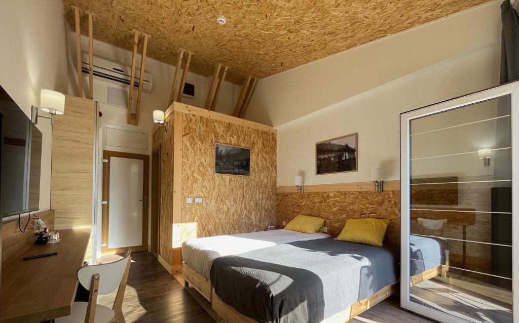 a bedroom with a king sized bed in a room at Luby Panzió 