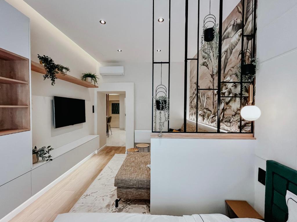 a living room with a couch and a tv at Paulay 11 Center Designer Apartment in Budapest