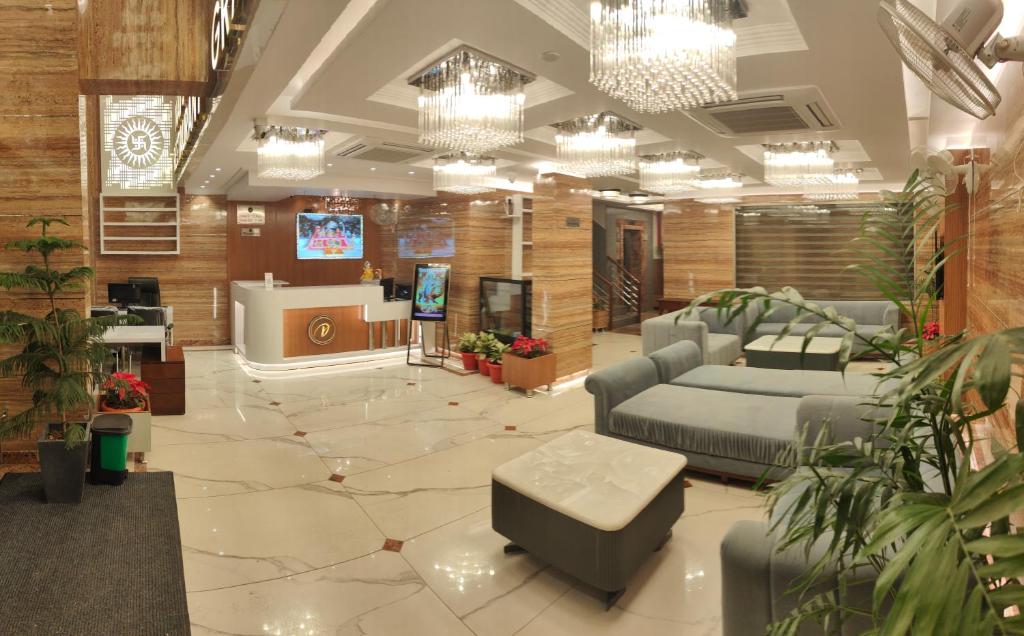 a large lobby with beds and a tv in it at Hotel The Grand Dewan in Katra