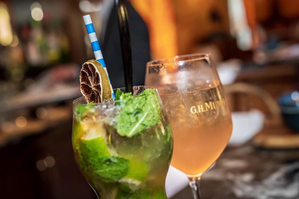 a couple of drinks sitting on a table at Le Manoir De La Poterie & Spa in Cricquebœuf
