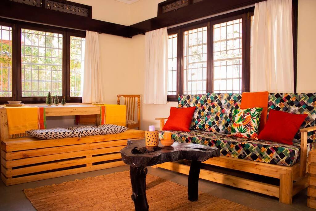 a living room with a couch and a table at Charming 2 bedroom house in Entebbe