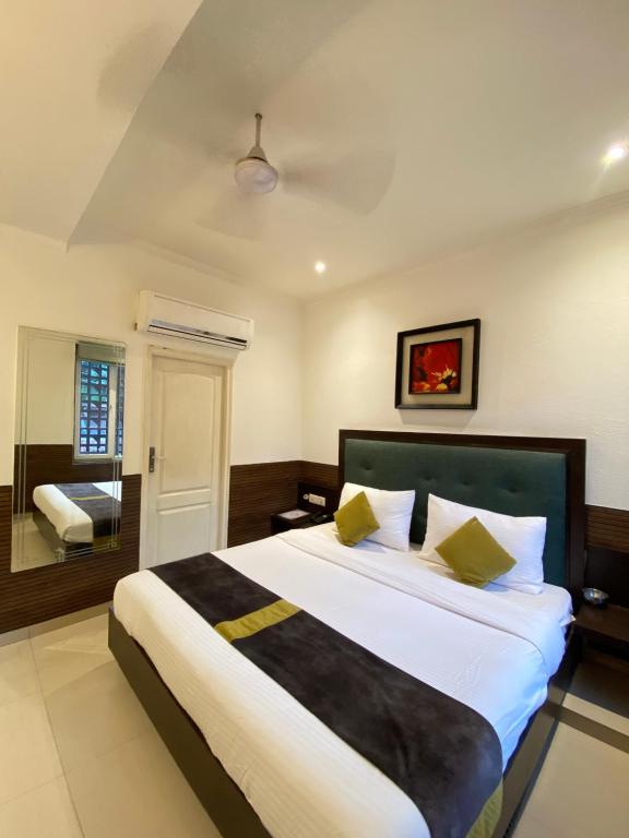 a bedroom with a large bed in a room at status business hotel in Kānpur
