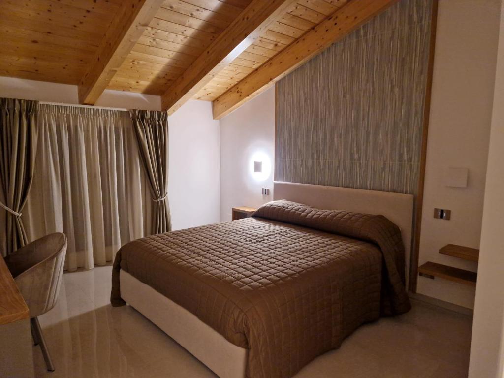 a bedroom with a bed and a large window at Otium Relais in Furore