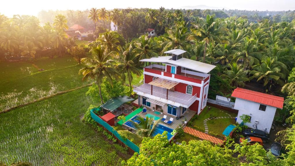 an aerial view of a house with a playground at Spicy Mango Villa Elegano - Luxurious Villa Near Nagaon Beach, Alibag in Nagaon