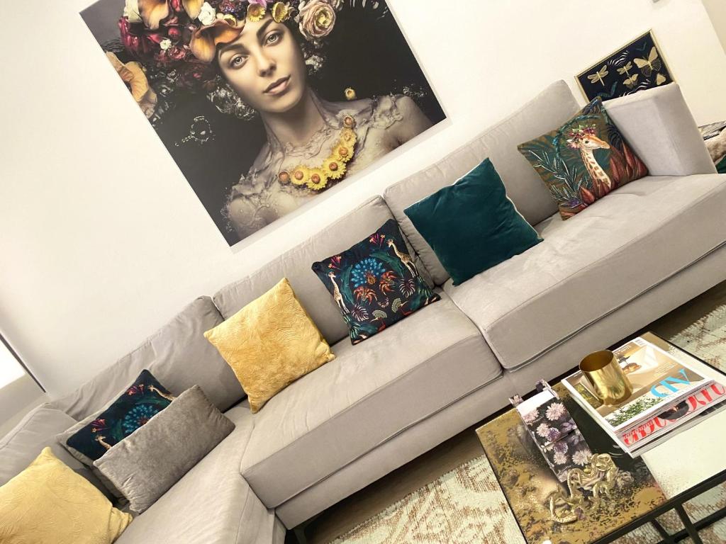 a living room with a couch with pillows at Barcelona New Apartment- Free Parking- 10 min by metro from BCN Center and Sagrada Família in Barcelona