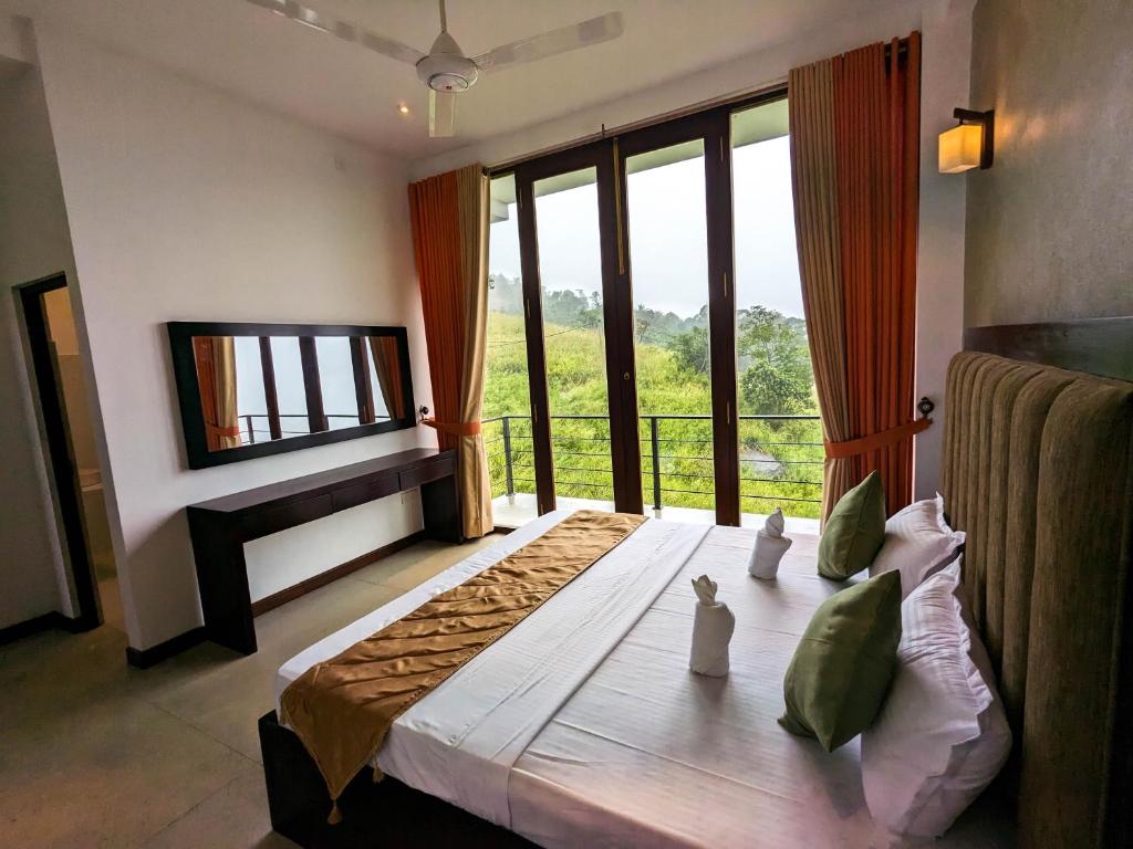 a bedroom with a bed with a large window at The Aurelia in Gampola