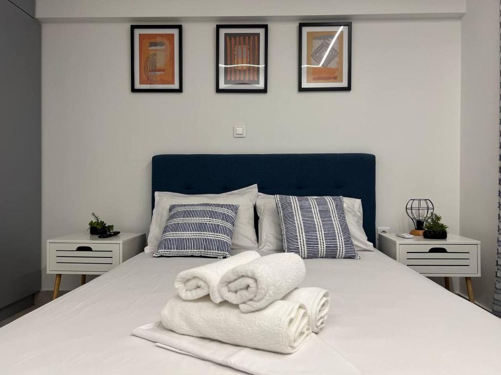 a bedroom with a bed with towels on it at Attiki Apartment vipgreece in Athens