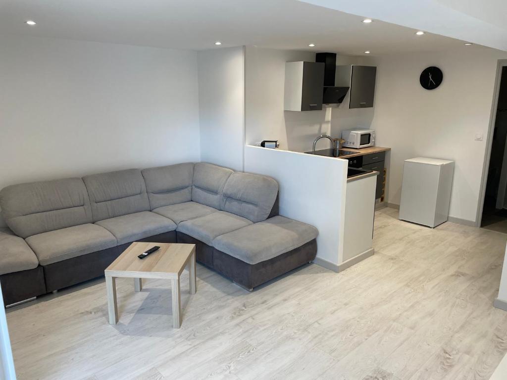 a living room with a couch and a table at Joli logement au pied des Alpilles in Eyguières