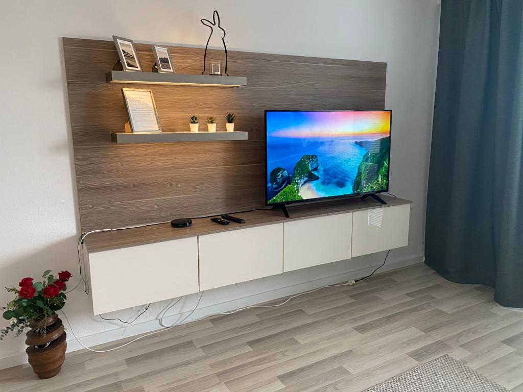 a living room with a flat screen tv on a white cabinet at Self check in with parking included in Bratislava