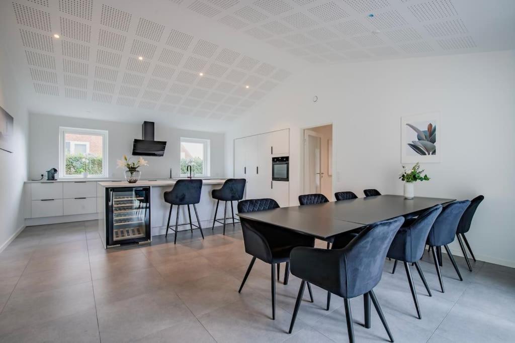 a kitchen and dining room with a table and chairs at Spacious family house in Copenhagen