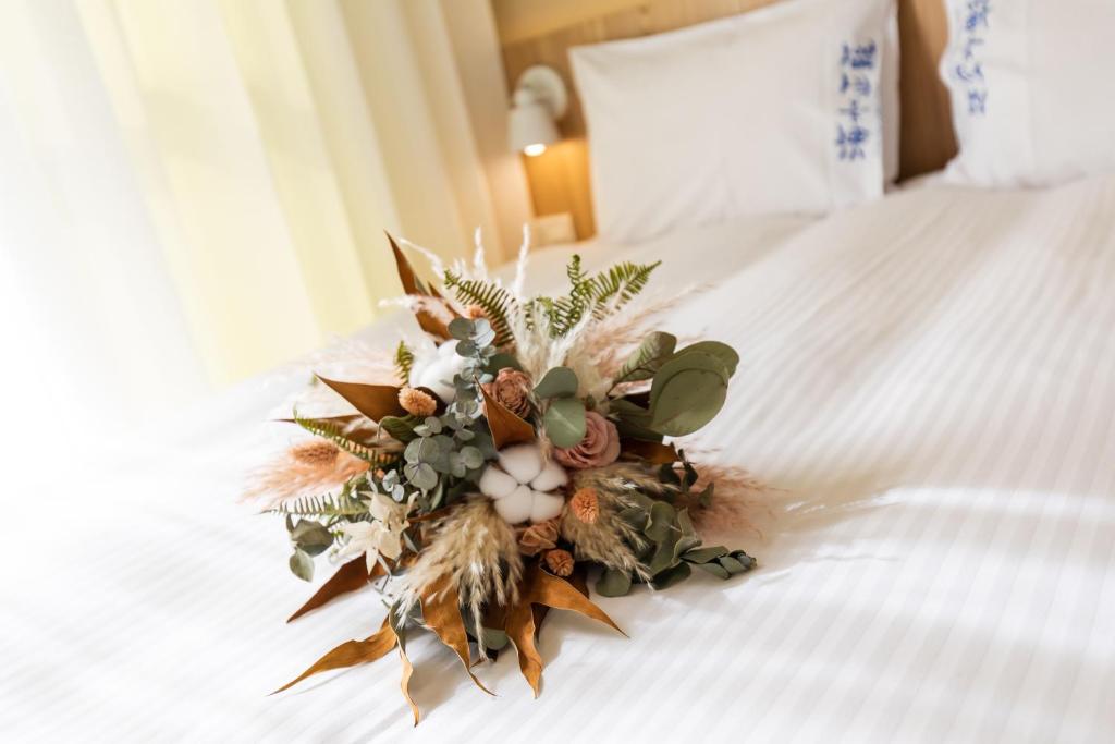 a bouquet of flowers sitting on a bed at Blue Lagoon in Huxi