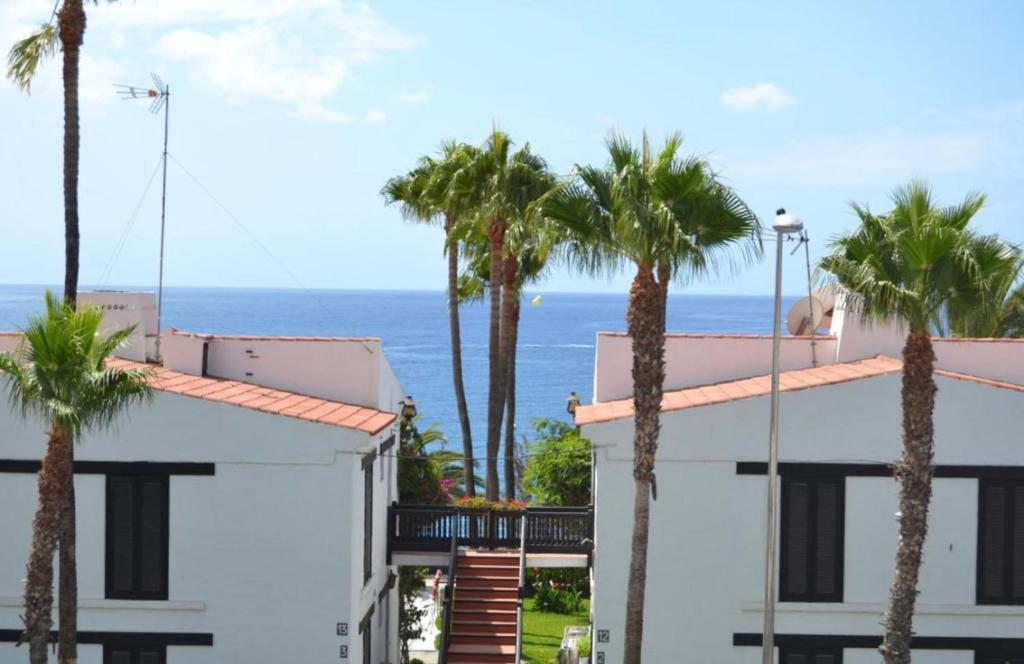 a view of the ocean from a building with palm trees at Ocean blue 405 in San Bartolomé