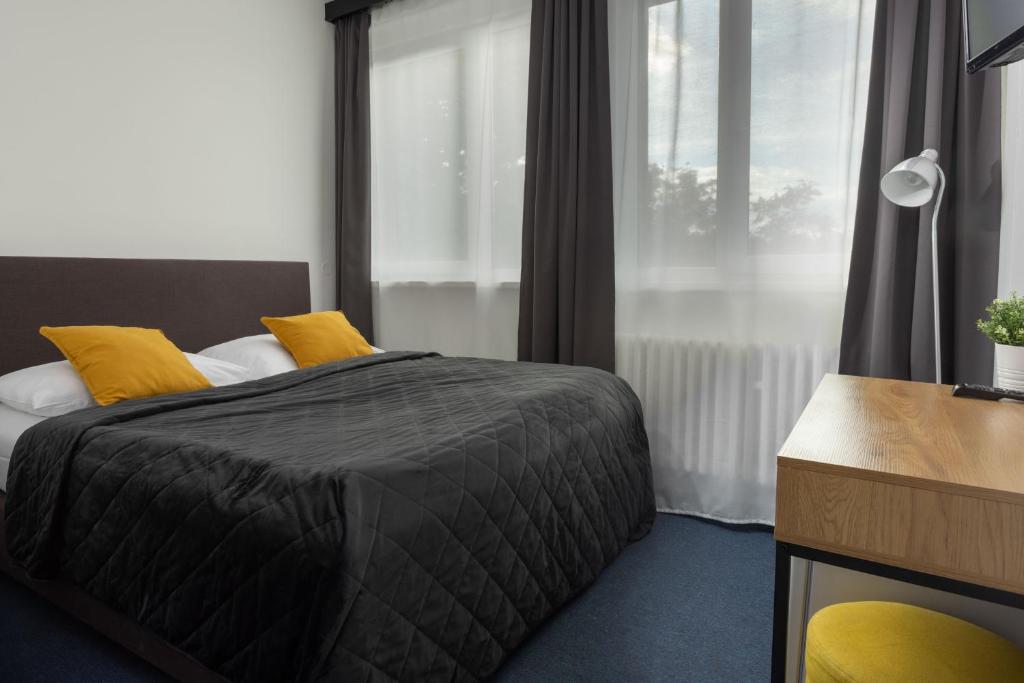 Postel nebo postele na pokoji v ubytování Hotel AMITY
