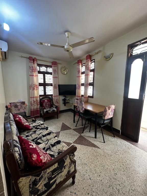 a living room with a couch and a table at Yahya Apartments in Ngambo