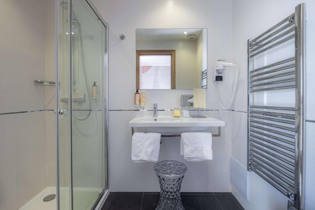 a bathroom with a sink and a shower at Best Western Premier Hotel Prince de Galles in Menton