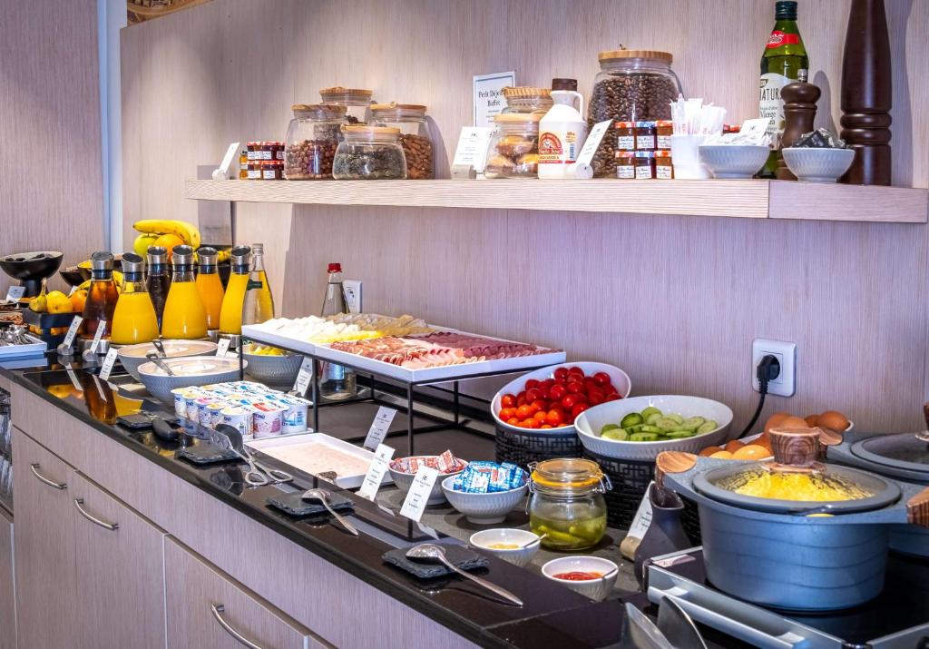 a buffet line with many different types of food at Best Western Premier Hotel Prince de Galles in Menton