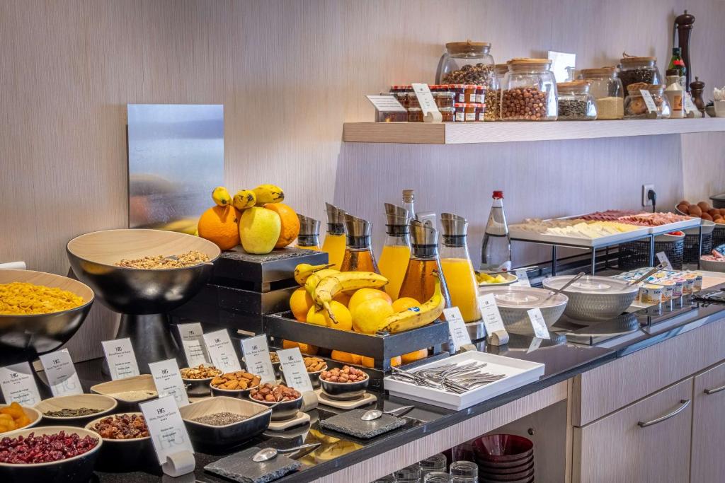 a buffet line with various food items on display at Best Western Premier Hotel Prince de Galles in Menton