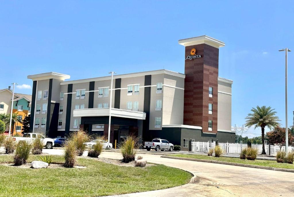 a building with a clock tower on top of it at La Quinta by Wyndham Gonzales LA in Gonzales