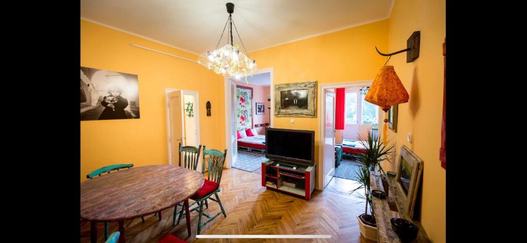 a living room with a table and a dining room at Cosy Art flats in central Budapest in Budapest