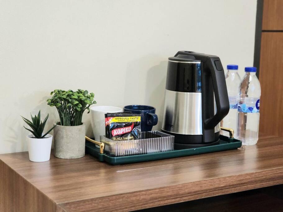 a coffee maker on a tray on a counter at Cozy Comfy 1BR w/ Mall access Netflix Fast Wi-fi in Manila