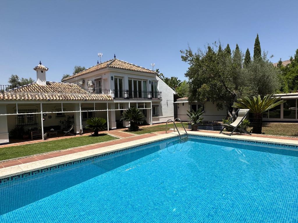 a large swimming pool in front of a house at Casa Ciaurriz in Mairena del Aljarafe