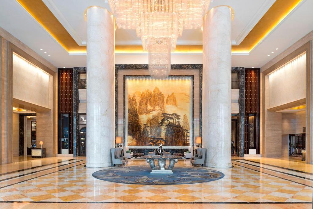 a lobby with a chandelier and a fountain at The Westin Hefei Baohe in Hefei